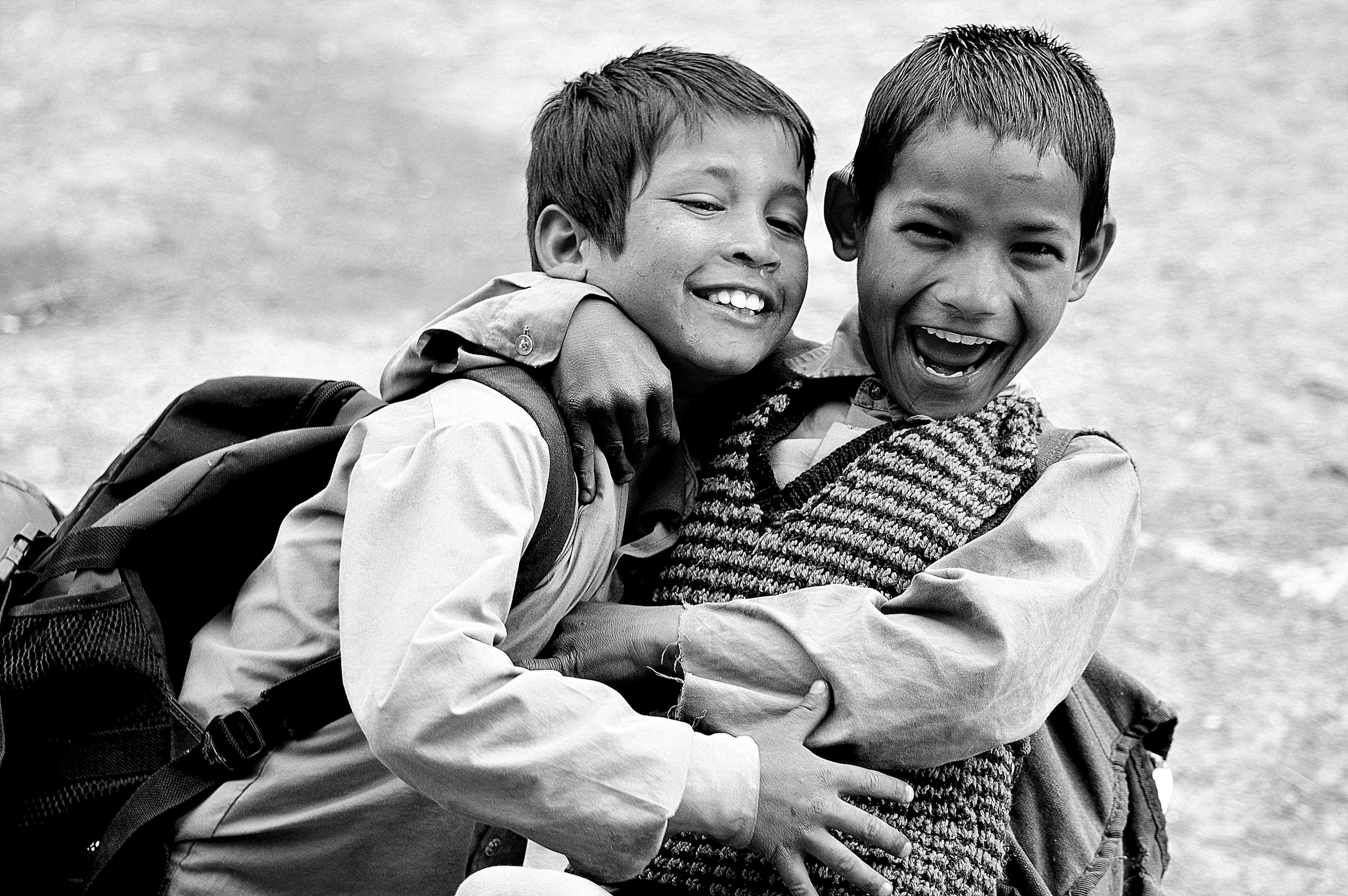Two boys laughing and hugging